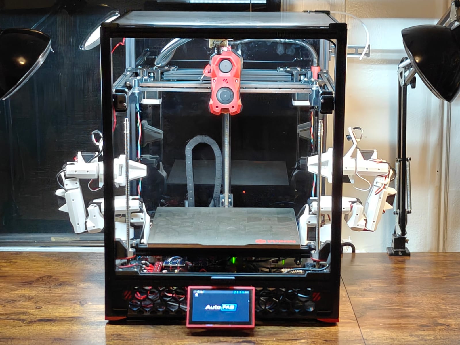 AutoFAB V1, printer and dual arms behind glass.